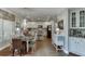 Bright kitchen features white cabinets, stainless steel appliances, island, and a breakfast nook at 3930 Suwanee Bend Dr, Suwanee, GA 30024