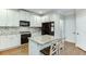 Well-lit kitchen featuring white cabinets, granite countertops, and stainless steel appliances at 3930 Suwanee Bend Dr, Suwanee, GA 30024