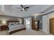 Main bedroom with carpet, tray ceiling, ensuite access, and bedside tables at 3930 Suwanee Bend Dr, Suwanee, GA 30024