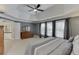 Main bedroom featuring a tray ceiling, neutral carpet, and large windows at 3930 Suwanee Bend Dr, Suwanee, GA 30024