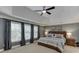 Spacious main bedroom featuring a tray ceiling, neutral carpet, and large windows at 3930 Suwanee Bend Dr, Suwanee, GA 30024