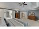 Main bedroom with carpet, tray ceiling, ensuite access, and dresser at 3930 Suwanee Bend Dr, Suwanee, GA 30024
