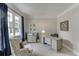 Bright home office with large windows, comfortable chair, and stylish desk at 3930 Suwanee Bend Dr, Suwanee, GA 30024