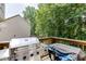 Outdoor cooking area with a stainless steel grill on a wooden deck at 3930 Suwanee Bend Dr, Suwanee, GA 30024
