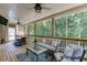 Screened porch featuring a comfortable seating area, ceiling fans, and outdoor dining at 3930 Suwanee Bend Dr, Suwanee, GA 30024