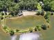 Breathtaking aerial view of the lake with its sandy beach and surrounding lush green landscape at 4624 Park Dr, Pine Lake, GA 30072