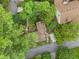 Home with well-manicured lawn in tree-lined neighborhood, aerial view at 4624 Park Dr, Pine Lake, GA 30072