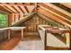 Spacious attic area featuring exposed rafters, shelves, and a window at 4624 Park Dr, Pine Lake, GA 30072