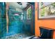 The bathroom features a stand up shower with teal tiling, stone flooring, and a window at 4624 Park Dr, Pine Lake, GA 30072