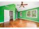 Bright bedroom with vaulted ceilings, hardwood floors, an open closet, and nature views at 4624 Park Dr, Pine Lake, GA 30072