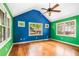 Cozy bedroom with hardwood floors, vaulted ceilings, and windows offering a view of the outdoors at 4624 Park Dr, Pine Lake, GA 30072