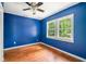 Cozy bedroom featuring hardwood floors, a ceiling fan, and a window view at 4624 Park Dr, Pine Lake, GA 30072
