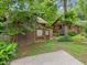 Exterior view of the home with wood paneling, garage, and stone walkway at 4624 Park Dr, Pine Lake, GA 30072