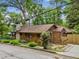 Charming bungalow featuring wood shingles, stone chimney, and a well-maintained yard at 4624 Park Dr, Pine Lake, GA 30072