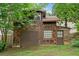 Detached garage with wood shingles, a garage door, and a pedestrian door at 4624 Park Dr, Pine Lake, GA 30072