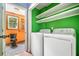 Laundry room with washer, dryer, shelving, and an adjacent view of a bathroom at 4624 Park Dr, Pine Lake, GA 30072