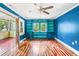 Bright living room with built-in shelves, hardwood floors, and red french doors at 4624 Park Dr, Pine Lake, GA 30072