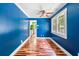 Living room featuring blue walls, hardwood floors, large windows, and white trim at 4624 Park Dr, Pine Lake, GA 30072