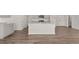 Open kitchen with a central island, granite countertops, stainless steel appliances and modern flooring at 6131 Knickerbocker St, Mableton, GA 30126