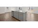 Kitchen island with granite counters, stainless steel sink and dishwasher, and modern gray cabinets at 6131 Knickerbocker St, Mableton, GA 30126