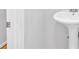 White pedestal sink in a minimalist half-bathroom with neutral paint at 6520 Roswell Rd # 48, Atlanta, GA 30328