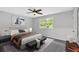 Cozy bedroom with queen bed, ceiling fan, and bright natural light at 6520 Roswell Rd # 48, Atlanta, GA 30328