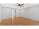 Empty bedroom with hardwood floors, neutral paint, ceiling fan, and an en-suite doorway at 6520 Roswell Rd # 48, Atlanta, GA 30328