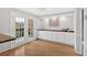 Bright dining room featuring hardwood floors, built-in cabinetry, and French doors to balcony at 6520 Roswell Rd # 48, Atlanta, GA 30328