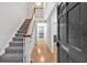 Inviting foyer with hardwood floors, staircase, and open view into the kitchen at 6520 Roswell Rd # 48, Atlanta, GA 30328