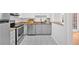 Modern kitchen with stainless steel appliances, granite countertops, and access to the dining area at 6520 Roswell Rd # 48, Atlanta, GA 30328