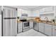 Modern kitchen with stainless steel appliances, granite countertops, and white cabinets at 6520 Roswell Rd # 48, Atlanta, GA 30328