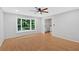 Bright living room with beautiful hardwood floors, ceiling fan, and large windows at 6520 Roswell Rd # 48, Atlanta, GA 30328
