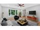 Bright living room featuring a ceiling fan, large window, and stylish furnishings at 6520 Roswell Rd # 48, Atlanta, GA 30328