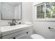 Modern bathroom featuring a sleek vanity with a white countertop and marble shower at 1712 Evans Sw Dr, Atlanta, GA 30310