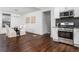 Open concept dining and kitchen area with hardwood floors, white cabinets, and stainless appliances at 1712 Evans Sw Dr, Atlanta, GA 30310