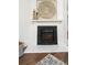 Close-up of fireplace with decorative art, a marble hearth, and a textured stone surround at 1712 Evans Sw Dr, Atlanta, GA 30310