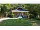 Charming home with neutral siding, covered front porch, and a well-maintained lawn and trees at 1712 Evans Sw Dr, Atlanta, GA 30310