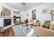 Bright living room with fireplace, hardwood floors, neutral paint, and natural light from a large window at 1712 Evans Sw Dr, Atlanta, GA 30310