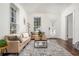Well-lit living room with hardwood floors, neutral furnishings, and a large window at 1712 Evans Sw Dr, Atlanta, GA 30310