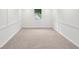 Finished basement with white walls, neutral carpet, and bright window at 1915 North Rd, Snellville, GA 30078