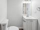 This neutral bathroom features a vanity with storage, and updated lighting at 1915 North Rd, Snellville, GA 30078