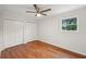 This bedroom has a ceiling fan, natural light, and beautiful wood flooring at 1915 North Rd, Snellville, GA 30078