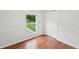This bedroom has beadboard, natural light, and beautiful wood flooring at 1915 North Rd, Snellville, GA 30078