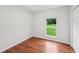 This bedroom has beadboard, natural light, and beautiful wood flooring at 1915 North Rd, Snellville, GA 30078