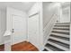 Welcoming foyer features hardwood floors, a staircase, and convenient coat closet at 1915 North Rd, Snellville, GA 30078