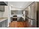 Updated kitchen features stainless steel appliances, granite countertops, and modern cabinetry at 1915 North Rd, Snellville, GA 30078