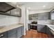 Updated kitchen offers gray cabinets, granite countertops, and stainless steel appliances at 1915 North Rd, Snellville, GA 30078