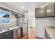 Updated kitchen with stainless steel appliances, granite countertops, and a view to the back yard at 1915 North Rd, Snellville, GA 30078