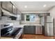 Modern kitchen features stainless steel appliances, gray cabinets and subway tile backsplash at 1915 North Rd, Snellville, GA 30078