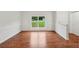 Bright living area showcasing hardwood floors, large windows, and fresh paint at 1915 North Rd, Snellville, GA 30078